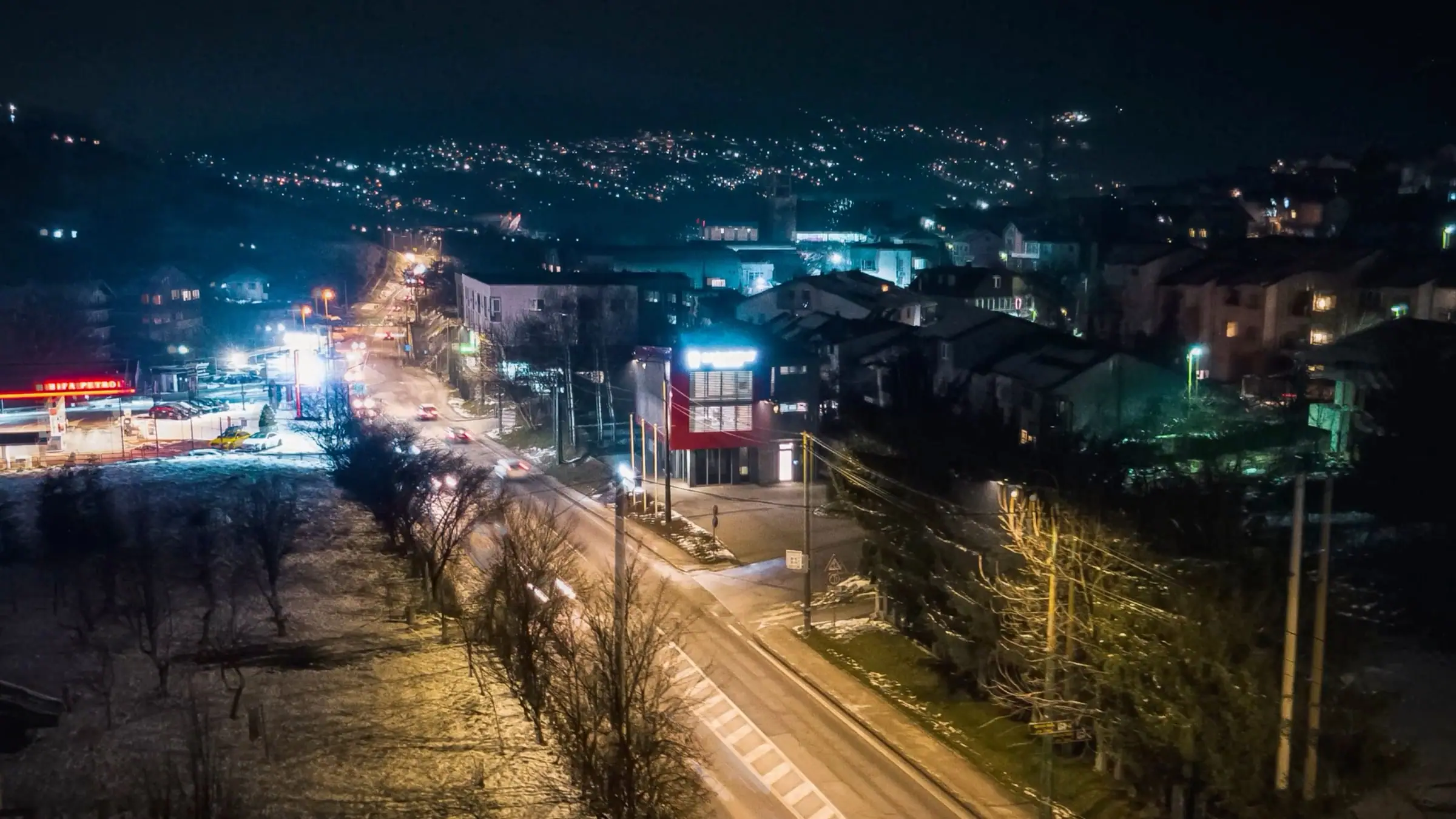 Aerial night view of the street and the Saradent clinic building