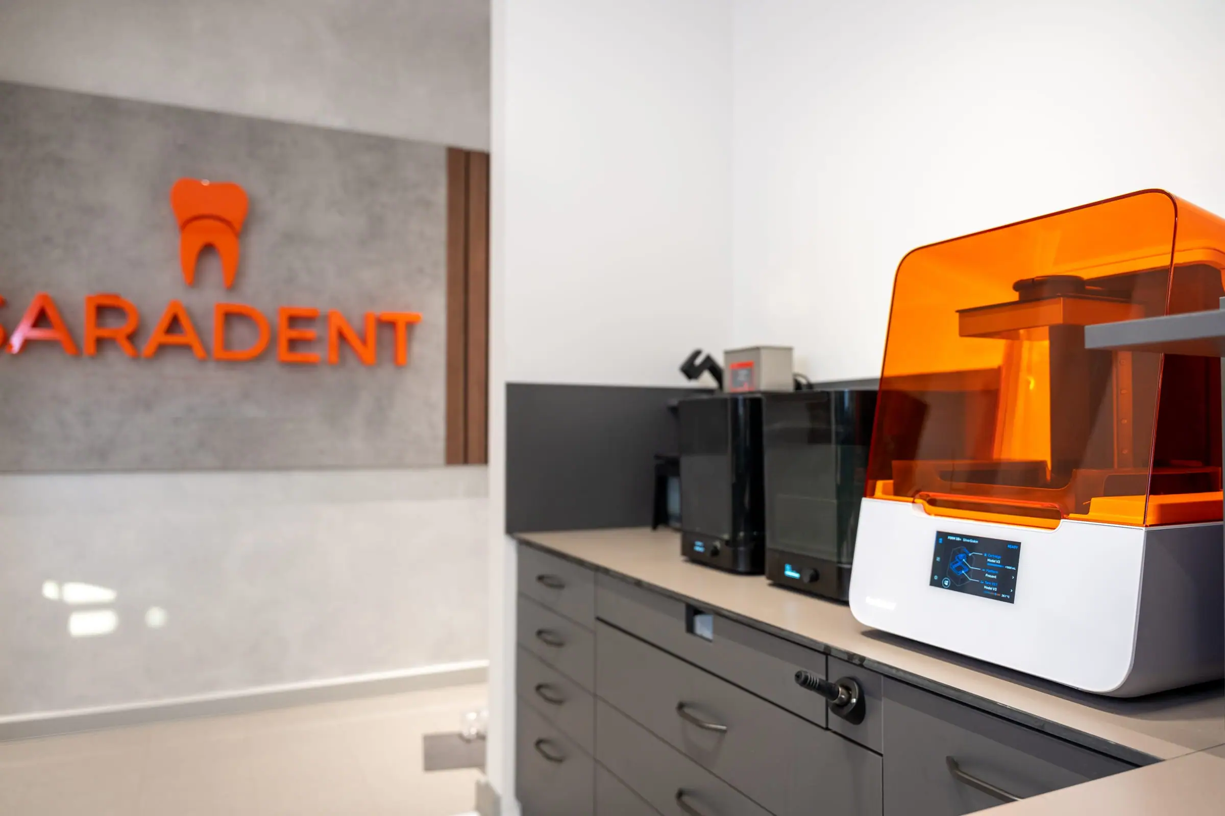 Saradent dental laboratory sign and a 3D printer in the laboratory